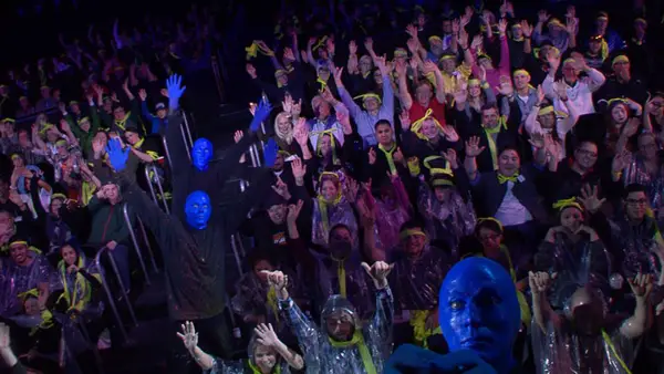 An audience being covered in paint during a Blue Man Group performance.