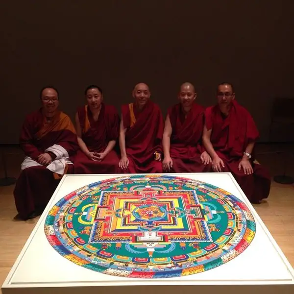 Five artists sitting beside their piece of work at the Asia Society and Museum.