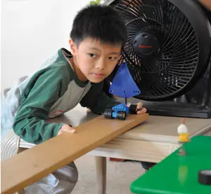 young boy creating a simple machine