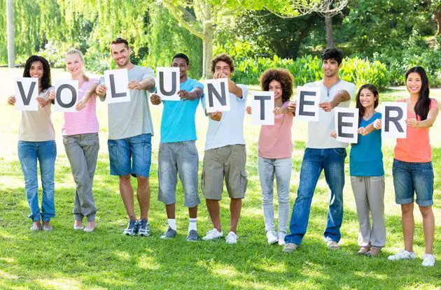 volunteers holding sign