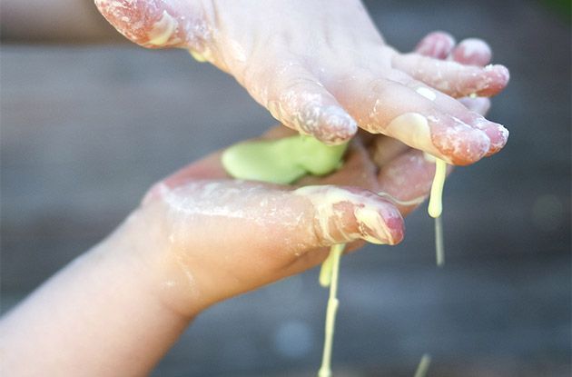 child's hands holding homemade slime