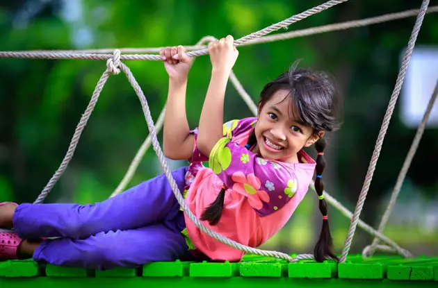 gril on rope bridge playground