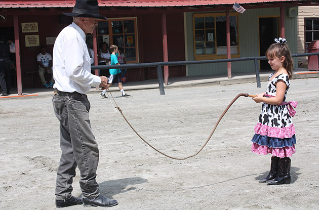 cowgirl holds bull whip