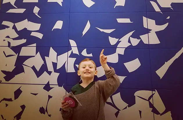 boy throwing papers