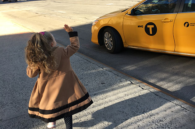 girl hailing taxi