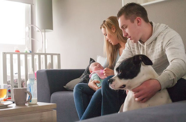 parents with newborn and dog