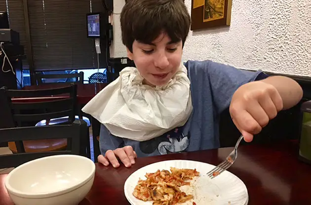 boy eating cut up pizza