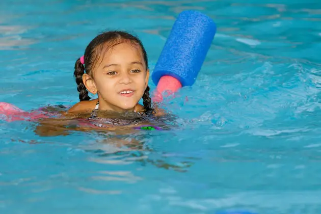 young girl swimming in pool