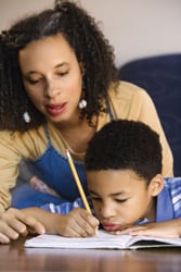teach your child not to give up; mother encouraging son; mother and son doing homework