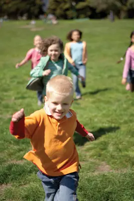 happy children running through a field