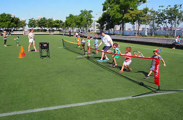 children learning to play tennis