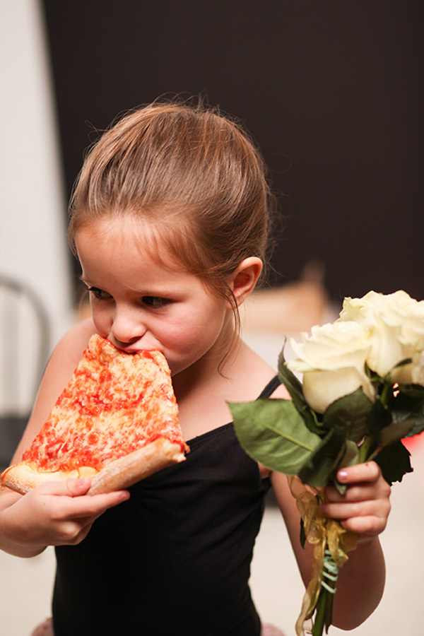 young ballernina eating pizza