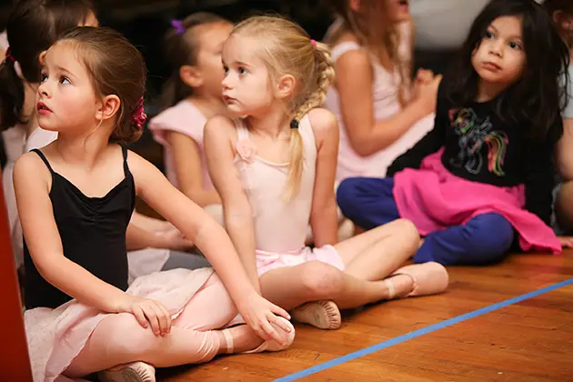 ballerinas listening to teacher