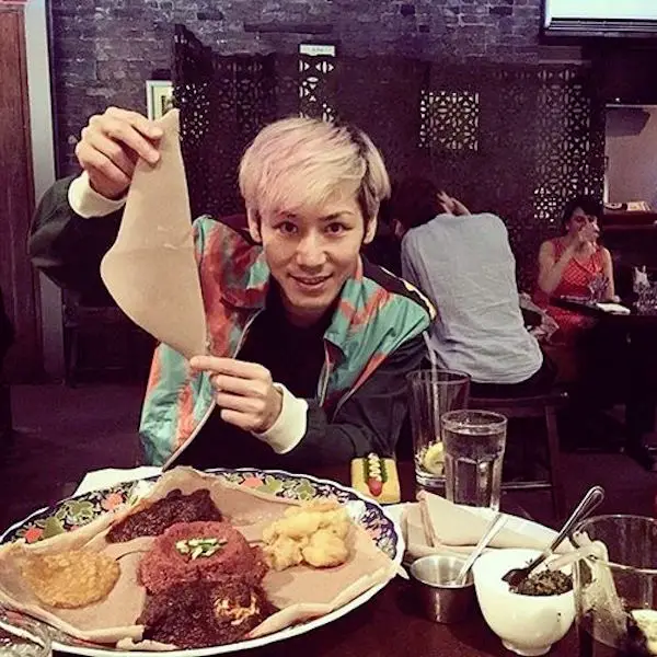 asian man holding injera 