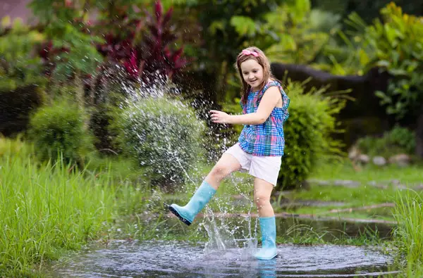 girl splashing in puddle
