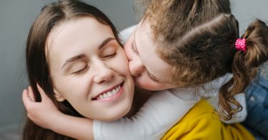 girl kissing nanny