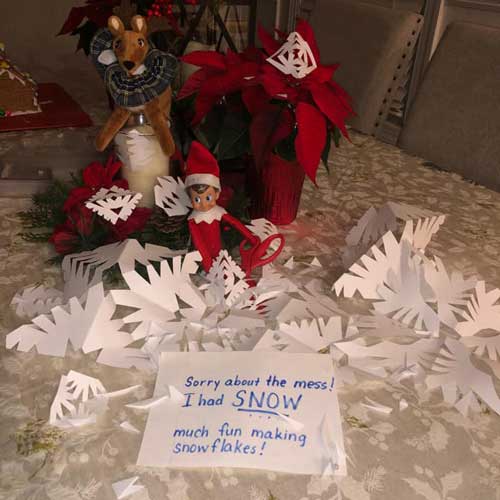 elf on the shelf making paper snowflakes
