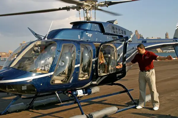 A Helicopter Flight Services Tour helicopter unloading passengers.