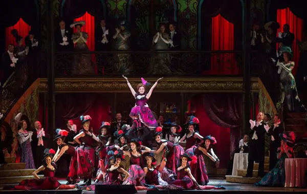 Actors singing on stage during a performance at the Metropolitan Opera.