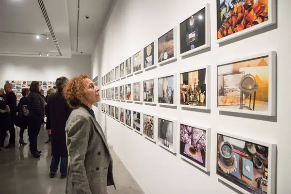 Visitors looking at a photography exhibition at the Bronx Museum of the Arts.