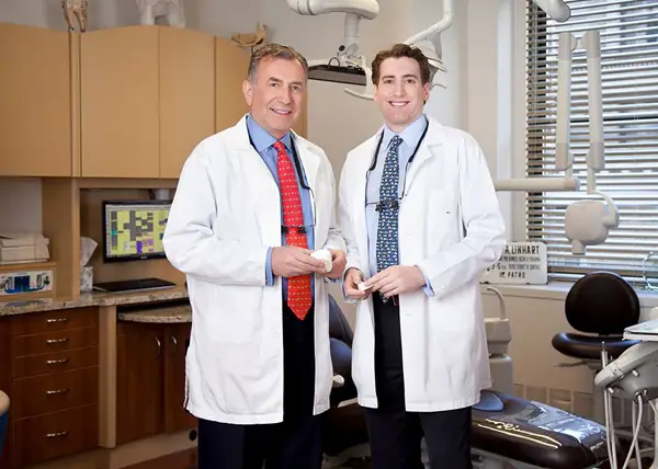 Dr. Linhart and his associate standing inside their dental office.