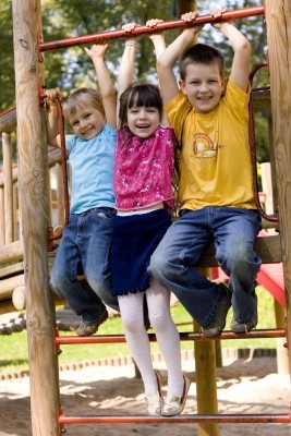 three kids playing on playground