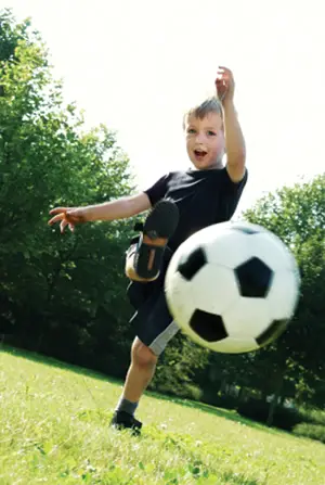 Boy Kicking Soccer Ball