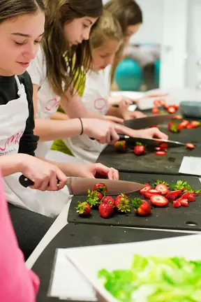 girls cooking with strawberries