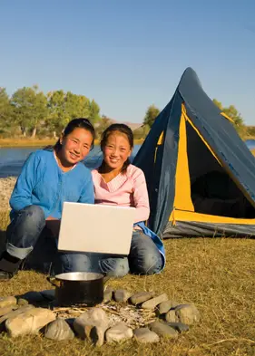 campers with laptop outside