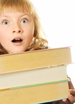 girl carrying books with a surprised look on her face