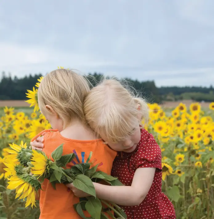 girls in sunflower field