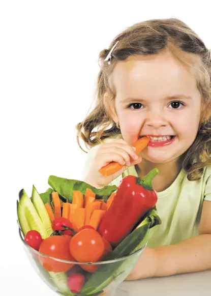 little girl eating vegetables