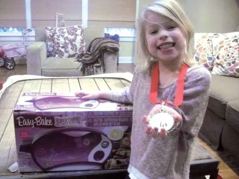 girl with easy bake oven and share your wish medal